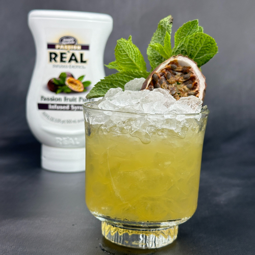 Passion Fruit Mai Tai garnished with mint sprig and dried passion fruit slice