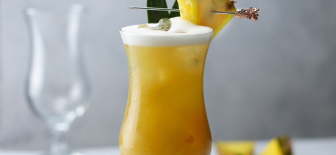 Pina Colada Glasses

1 Essence Pina Colada Glass filled with a yellow cocktail with a pineapple chunk on the rim of a glass with a skewer in it, along with a pineapple leaf and ice cubes. 1 Essence Pina Colada Glass blurred in the background along with some pineapple chunks and pineapple leaves.