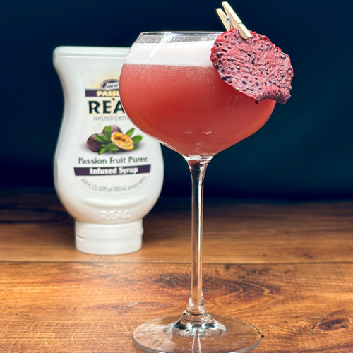 Dragon Star Martini garnished with dried dragon fruit slice